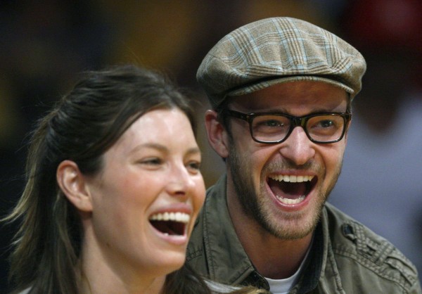The large eyeglass frames worn here by Justin Timberlake likely cause a blind spot for the musician/actor. He may not be aware that he's sitting next to Jessica Biel.