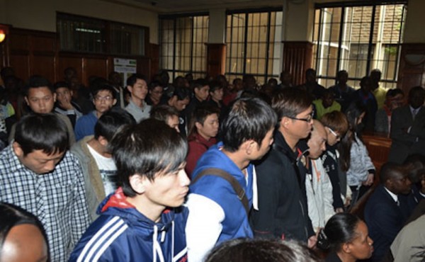 Some of the Chinese arrested in the sting appear at Milimani Law Courts. 