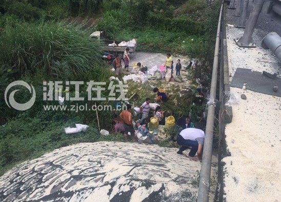 Local villagers are looting spilled rice.