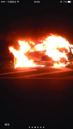 A car is burning on highway. 