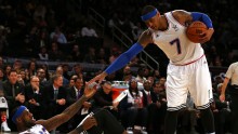 New York Knicks forward Carmelo Anthony (R) helps up Cleveland Cavaliers' LeBron James during an NBA All-Star Game