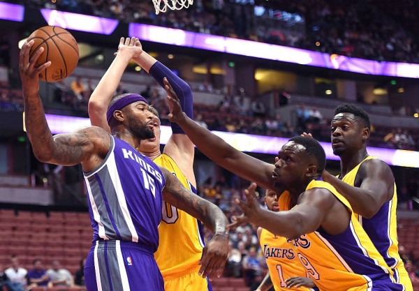 DeMarcus Cousins goes against three Los Angeles Lakers defenders