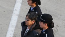 Yang Xiuzhu being escorted by Chinese police.