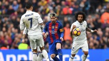 Barcelona forward Lionel Messi (middle) is surrounded by Real Madrid players Cristiano Ronaldo, Sergio Ramos, and Marcelo (R)