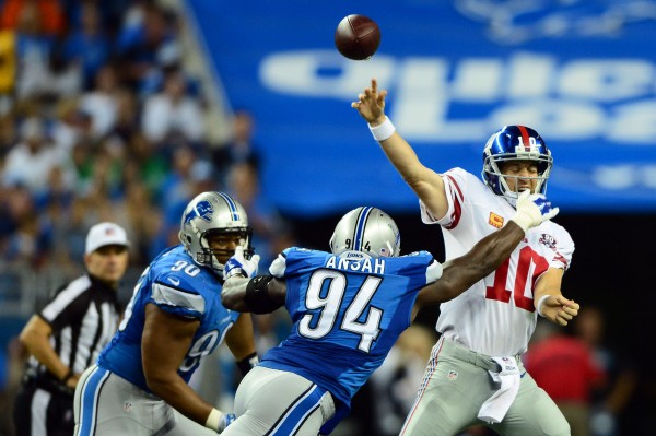 Detroit, MI, USA; New York Giants quarterback Eli Manning (10) is pressured by Detroit Lions defensive end Ezekiel Ansah (94) during the second quarter at Ford Field.