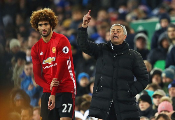 Manchester United midfielder Marouane Fellaini (L) with manager Jose Mourinho