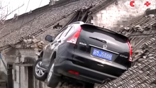 A Vehicle Crashes onto Roof in China. 