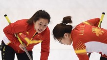 Chinese curlers Wang Rui (L) and Liu Jinli