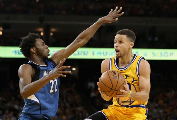 Minnesota Timberwolves' Andrew Wiggins (L) and Golden State Warriors' Stephen Curry