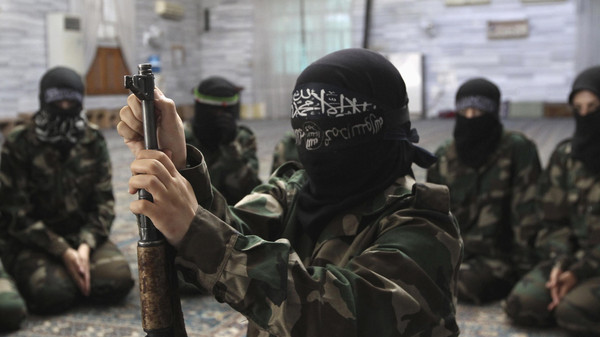 A female member of jihadist force Ahbab Al-Mustafa Battalion assembles a rifle during military training in the Seif El Dawla neighborhood in Aleppo.