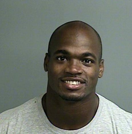 This photo provided by the Montgomery County sheriff’s office shows the booking photo of Adrian Peterson
