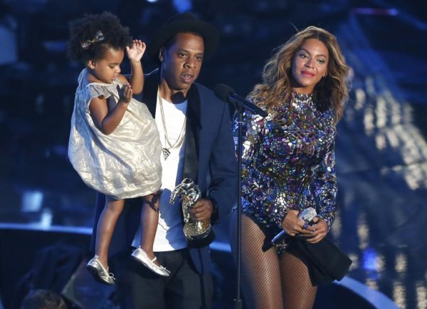 Jay-Z presents the Video Vanguard Award to Beyonce as he holds their daughter Ivy Blue during the 2014 MTV Video Music Awards in Inglewood, California Aug. 24, 2014