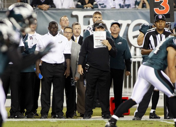Head Coach Chip Kelly relaying plays from the sidelines