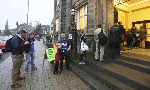 Voters wait for the polling station to open to cast their vote in Portobello near Edinburgh, Scotland, on Thursday.