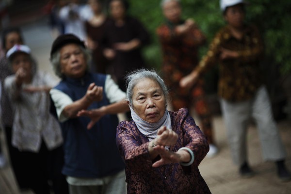 Elderly people exercise in a park in Hanoi, Vietnam