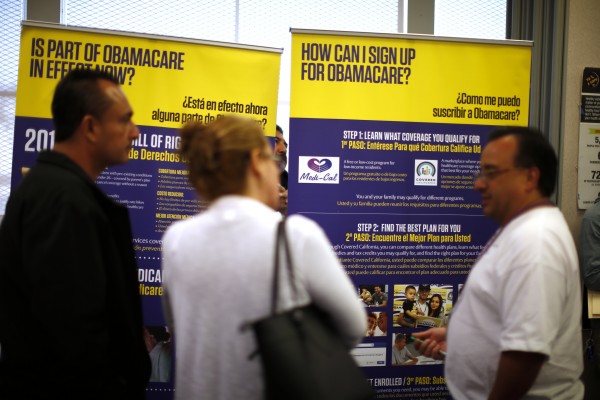 A man explains ObamaCare at a health insurance enrollment event in Commerce California, March 31, 2014.