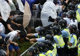 Riot police pepper spray Hong Kong protesters