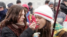 Supporters of opposition presidential candidate Alexander Milinkevich share a yogurt