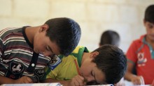 Children attend a class during the first day of school in Idlib countryside September 11, 2014.