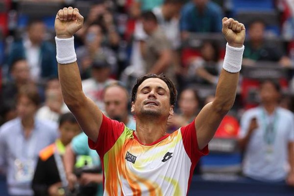 David Ferrer raises his arms in jubilation after winning his third round match against Andy Murray at the Shanghai Rolex Masters in China