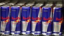 Red Bull drink cans in a supermarket display.
