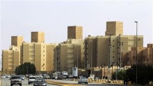 Cars drive past a housing compound located south of the capital in Riyadh, December 17, 2012.