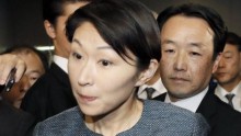 Japanese Minister of Economy, Trade and Industry Yuko Obuchi (C) is besieged by reporters in Tokyo, October 18, 2014.