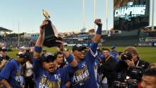 Oct 15, 2014; Kansas City, MO, USA; Kansas City Royals second baseman Omar Infante (left) celebrates with catcher Salvador Perez (right) with the American League championship trophy after game four of the 2014 ALCS playoff baseball game against the Baltim