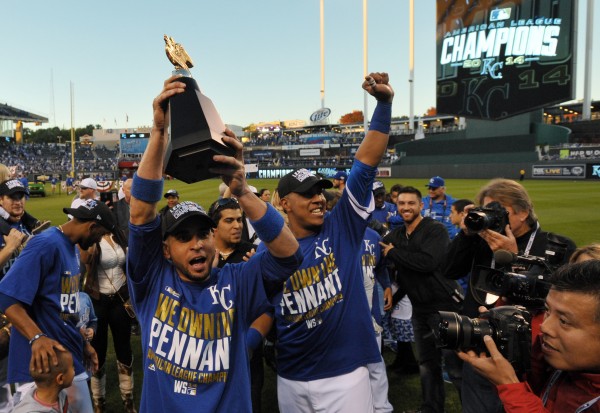 Oct 15, 2014; Kansas City, MO, USA; Kansas City Royals second baseman Omar Infante (left) celebrates with catcher Salvador Perez (right) with the American League championship trophy after game four of the 2014 ALCS playoff baseball game against the Baltim
