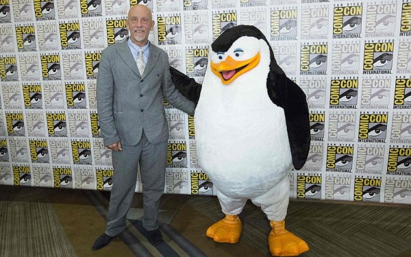John Malkovich, who voices "Dave", poses with the character "Skipper" from 'Penguins of Madagascar.'