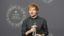 Singer Ed Sheeran poses backstage after winning the award for best male video for 