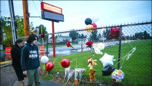 A memorial grows Saturday Oct. 25, 2014 at the entrance to Marysville Pilchuck High School