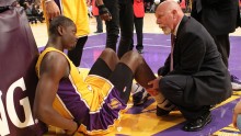 Head athletic trainer Gary Vitti attends to Lakers rookie Julius Randle. 