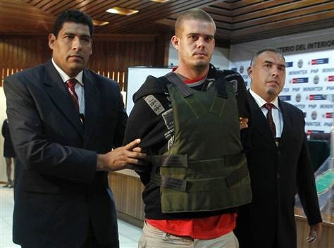 Joran Van der Sloot, center, is escorted by Peruvian police officers at the police headquarters in Lima, in 2010.