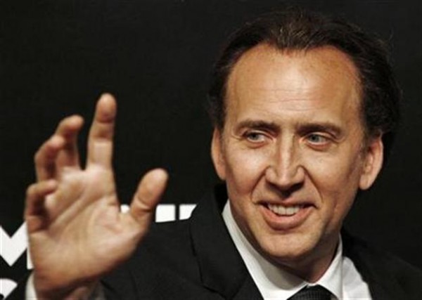 Nicolas Cage waves as he arrives at a replica of a street in Monte Carlo ahead of a launch ceremony of Mont Blanc's new Princesse Grace de Monaco jewelry collection inside the Mont Blanc concept store in Beijing June 1, 2012.