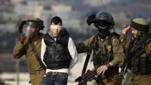Israeli soldiers arrest a Palestinian during clashes with Israeli troops at a protest against the Jewish settlement of Ofra in the West Bank village of Silwad, near Ramallah January 17, 2014.