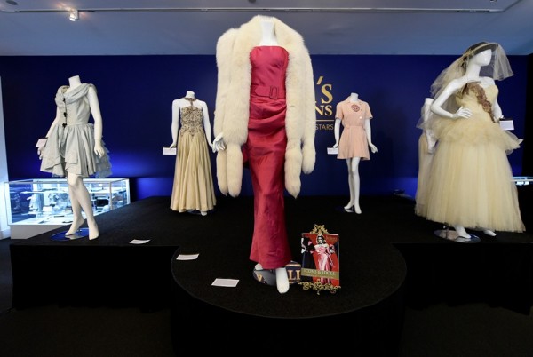 The "Material Girl" gown (C) worn by Madonna in her music video is pictured next to her wedding dress to actor Sean Penn, at Julien's Auctions for the upcoming "Icons & Idols: Rock n Roll" auction in Beverly Hills, California November 3, 2014.