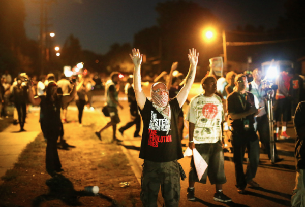 Demonstrators protest the shooting death of teenager Michael Brown on August 13, 2014 in Ferguson
