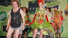 TV personality Richard Simmons (L) leads a parade of models dressed in clothing adorned with fruit and vegetables, both real and faux, during a ''summer salad fashion show'' at New York's Grand Central Terminal June 2, 2006.