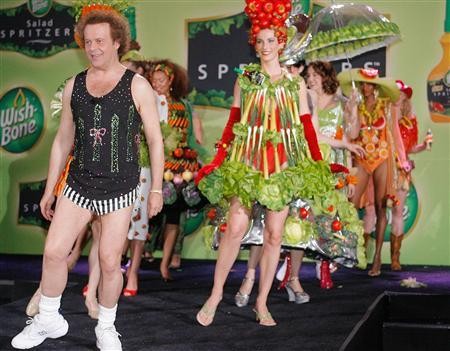 TV personality Richard Simmons (L) leads a parade of models dressed in clothing adorned with fruit and vegetables, both real and faux, during a ''summer salad fashion show'' at New York's Grand Central Terminal June 2, 2006.