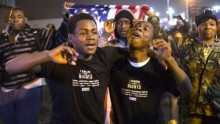 Protesters, demanding the criminal indictment of a white police officer who shot dead an unarmed black teenager in August, shout slogans while marching through a suburb in St. Louis, Missouri November 23, 2014.