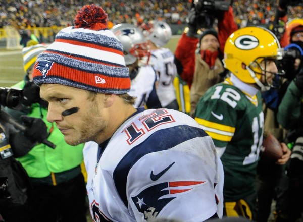 Nov 30, 2014; Green Bay, WI, USA; New England Patriots quarterback Tom Brady (12) walks away after shaking hands with Green Bay Packers quarterback Aaron Rodgers (12) at the end of the game at Lambeau Field. The Packers beat the Patriots 26-21. 