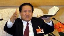 Chinese former Politburo Standing Committee Member Zhou Yongkang gestures as he speaks at a group discussion of Shaanxi Province during the National People's Congress at the Great Hall of the People.