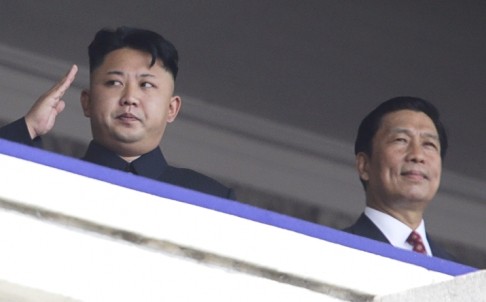 North Korean leader Kim Jong-un salutes as he watches a Pyongyang parade with Chinese Vice President Li Yuanchao.