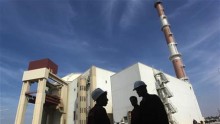 Iranian workers stand in front of the Bushehr nuclear power plant, about 1,200 km (746 miles) south of Tehran October 26, 2010.