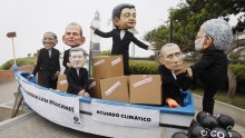 Activists wearing masks blast world leaders at climate change talks in Peru