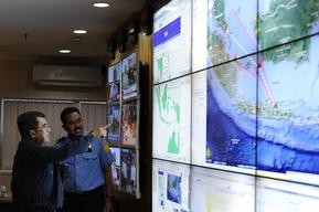 Indonesian officials study map of flight area 