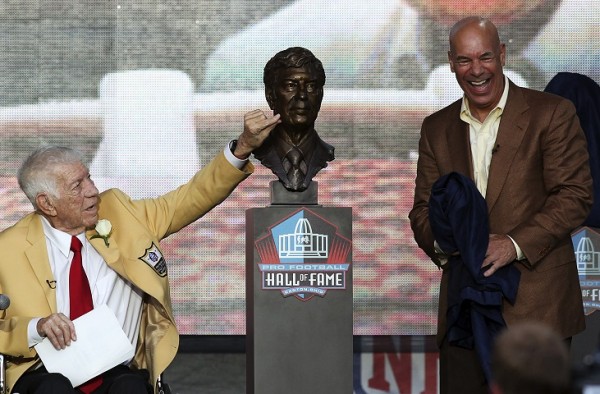 Scott Sabol (L) looks at his bust at the NFL Hall of Fame
