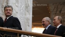 Ukraine Pres. Petro Poroshenko (L) looks back, followed by Belarussian Pres. Alexander Lukashenko & Russian Pres. Vladimir Putin (R) after a meeting in Minsk, Feb. 11, 2015.