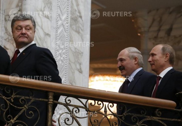 Ukraine Pres. Petro Poroshenko (L) looks back, followed by Belarussian Pres. Alexander Lukashenko & Russian Pres. Vladimir Putin (R) after a meeting in Minsk, Feb. 11, 2015.